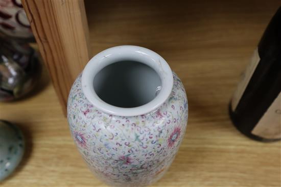 A Chinese famille rose ovoid vase, Qing dynasty, finely painted with flowers and scrolling foliage, H. 15cm, drilled hole to side of ba